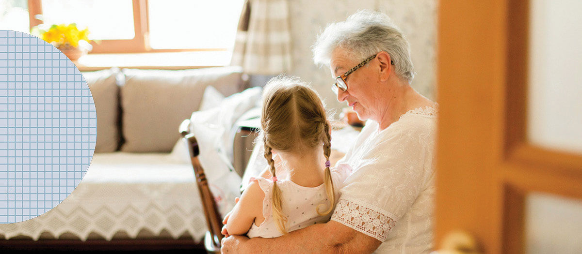 Senior woman holding granddaughter