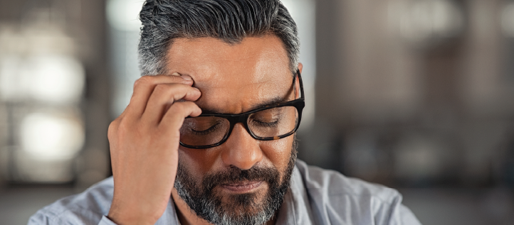 Middle age man holding his head in pain