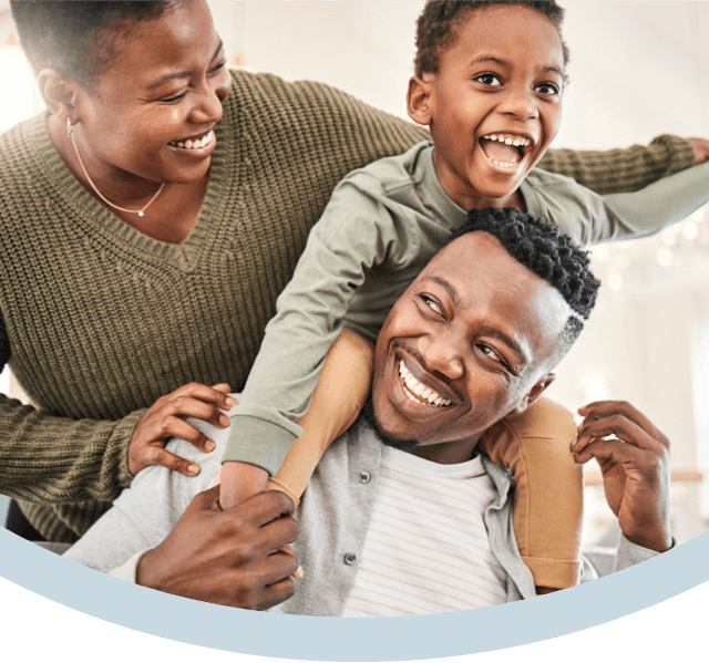 A family smiling together after finding the right dental plan