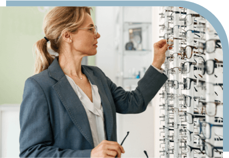 A woman with glasses shopping for frames