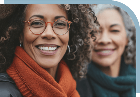 Two smiling older women looking for comprehensive coverage