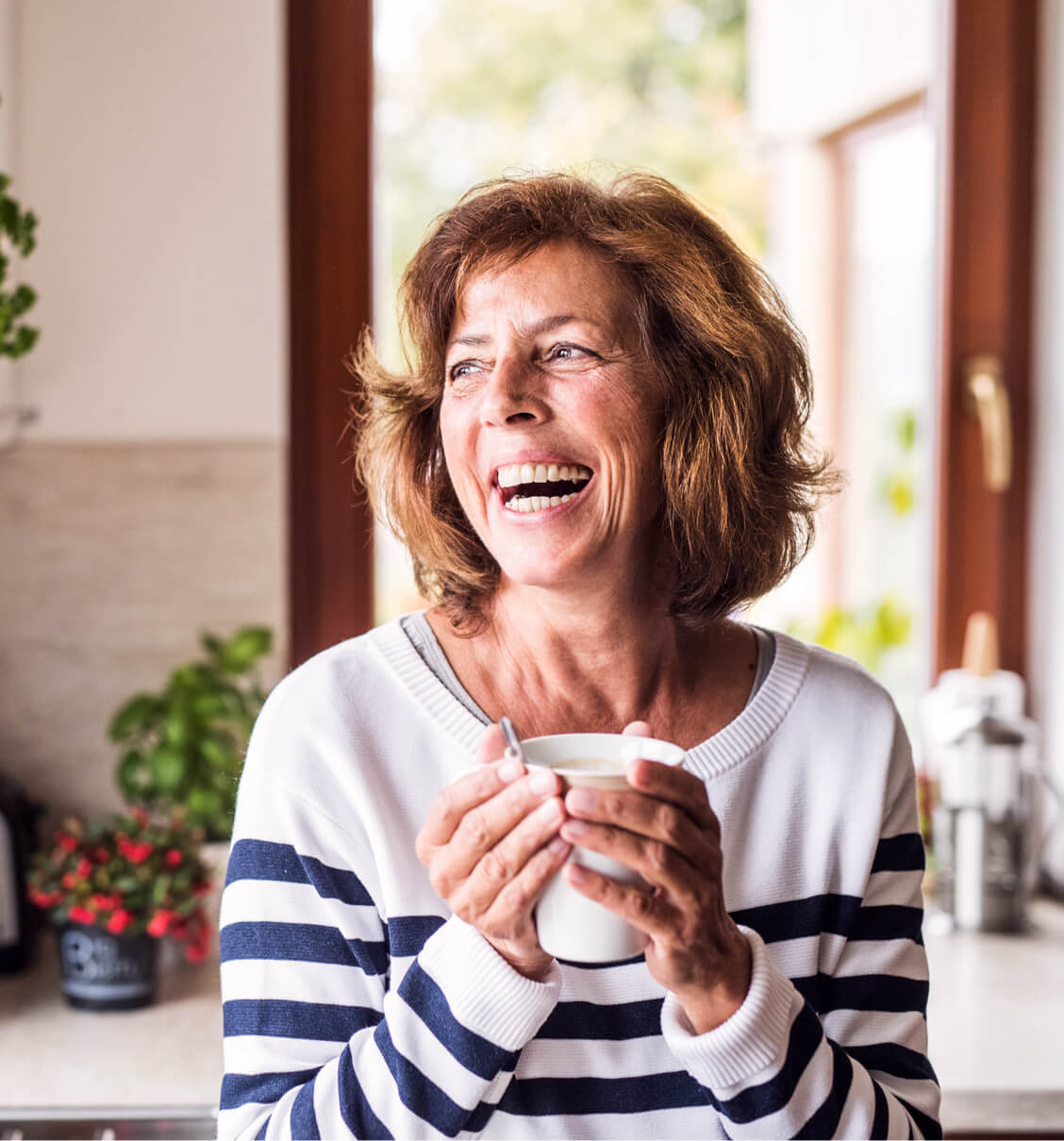 A woman smiling with affordable dental coverage