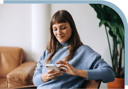 A woman checking her phone for dental coverage